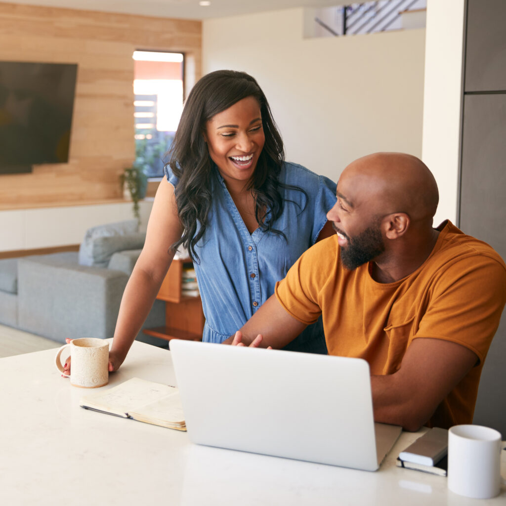 Couple searching for a rental property on a laptop