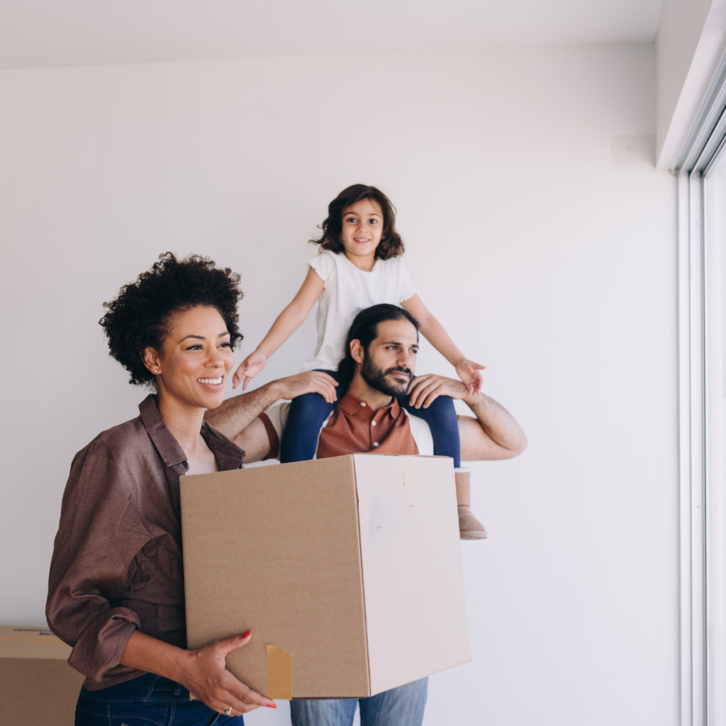 Family unpacking moving boxes during a temporary stay handled by short-term rental management Dallas TX.