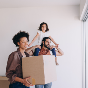Family unpacking moving boxes during a temporary stay handled by short-term rental management Dallas TX.