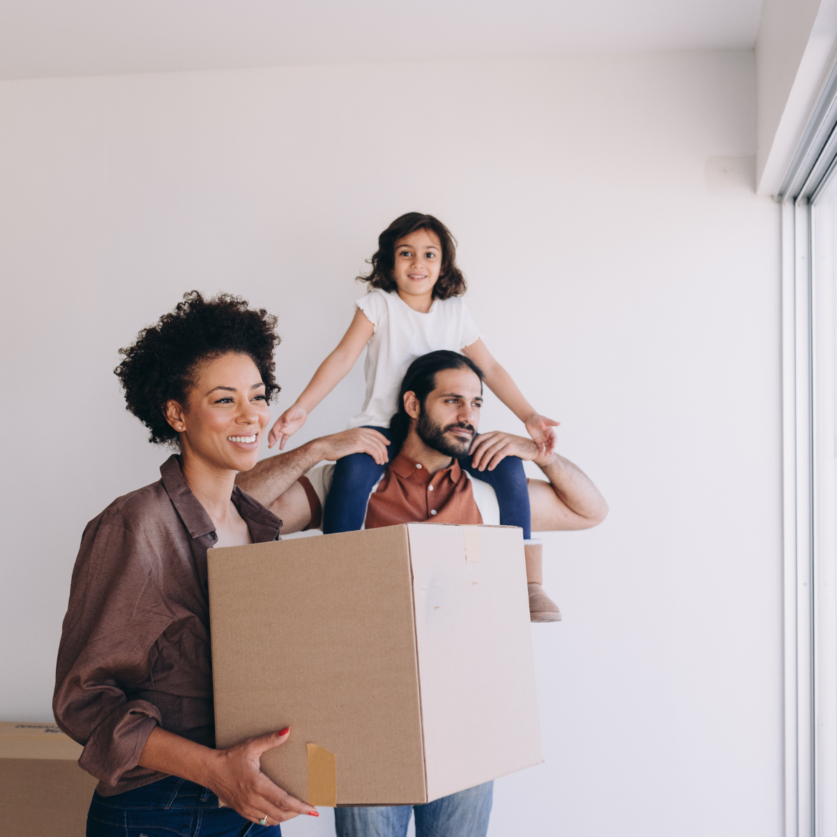 Family unpacking moving boxes during a temporary stay handled by short-term rental management Dallas TX.